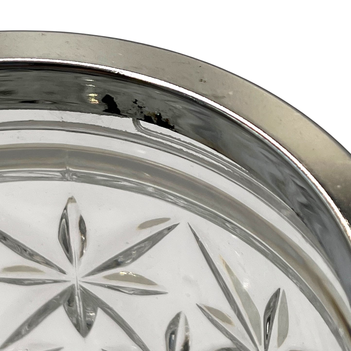Close up of French cut glass ice bucket with textured design and metal handle on a white background 