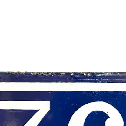 Close up of a French blue and white enamel door number - top edge