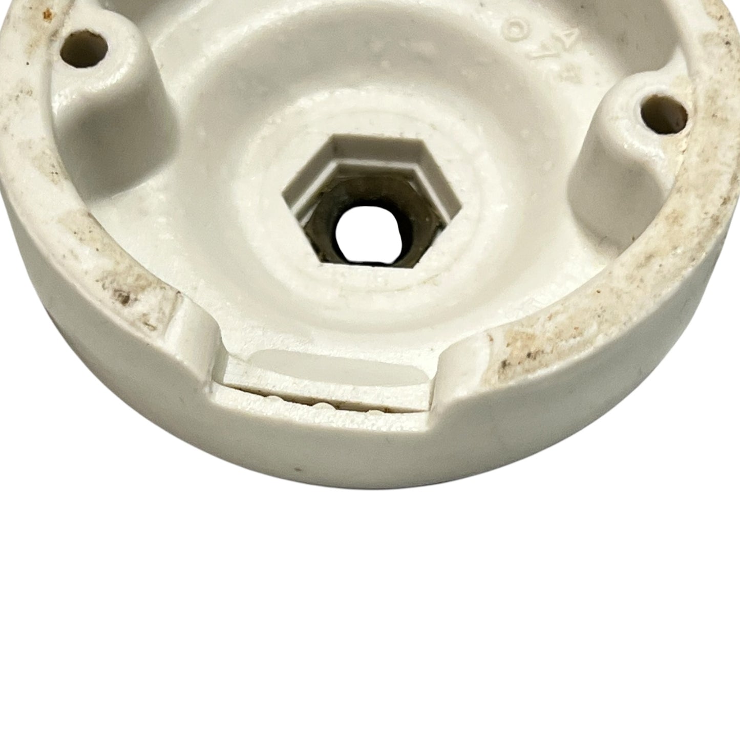 Small vintage French porcelain ceiling rose with a brass nut on a white background 