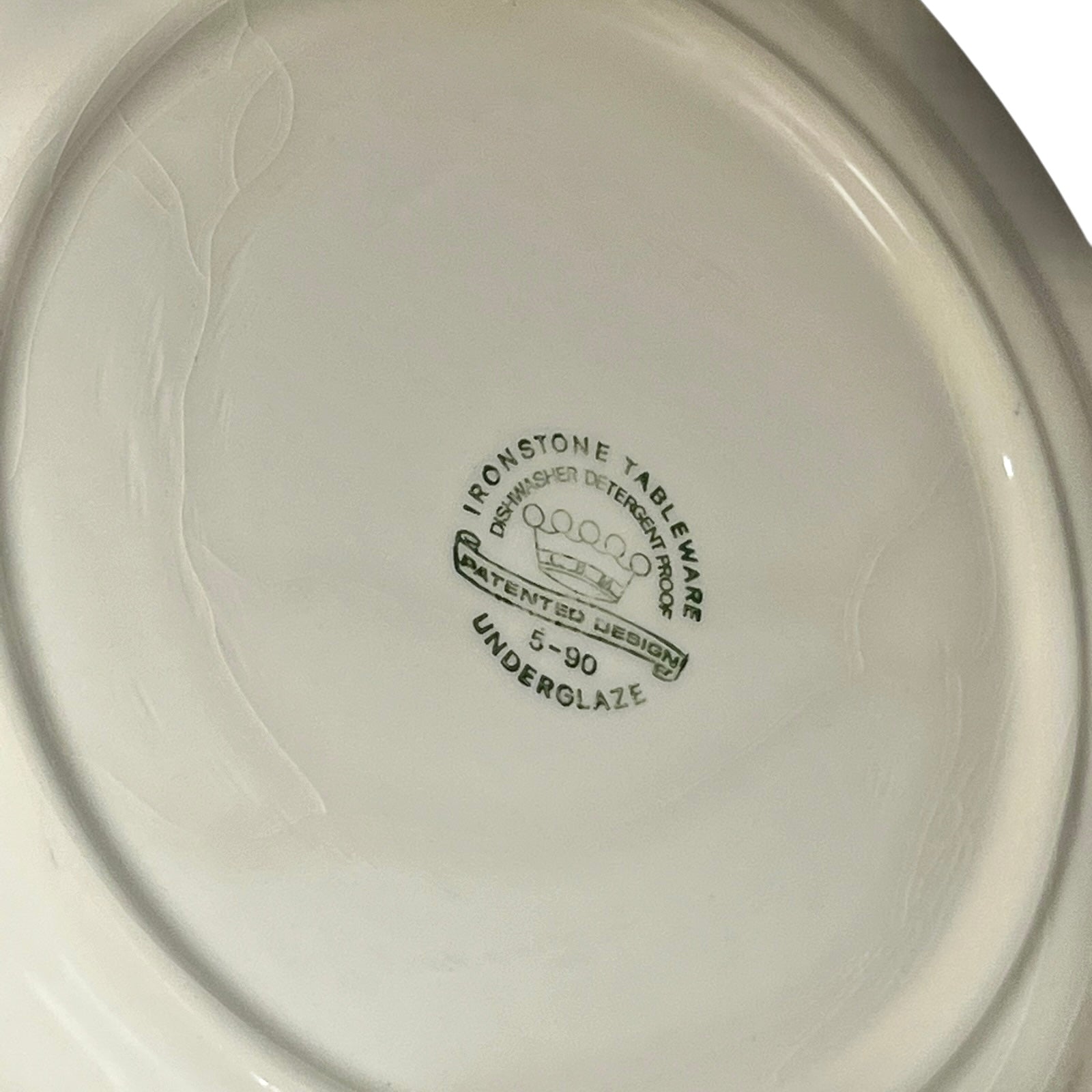 Close-up of a white ceramic plate with 'Ironstone Tableware' branding on a plain background.