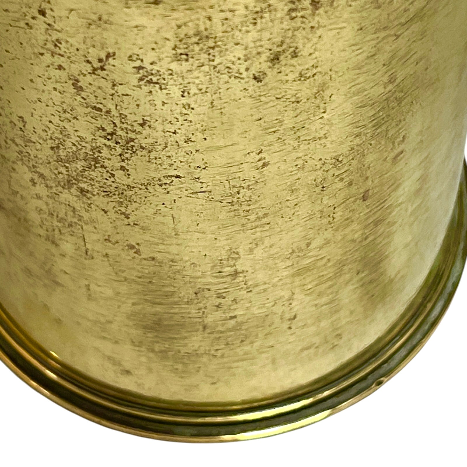 Close-up of a brass trench art shell case on a white background 
