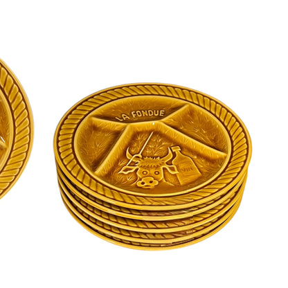 Stack of fondue plates with 'La Fondue' branding on a white background