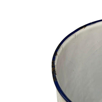 Close up of a French enamel vintage garden wall mounted planter or kitchen bathroom storage pot, on a white background 