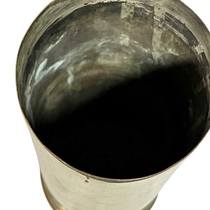 inside of a brass ww1 British militaria polished brass shell case on a white background 