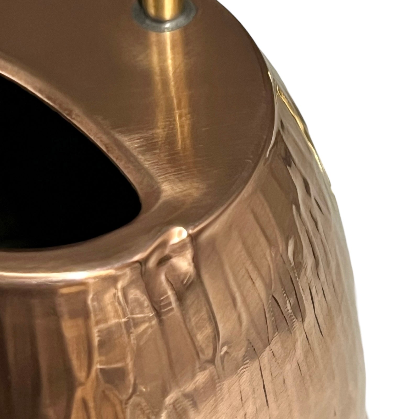 Close up of copper and brass watering can on a white background