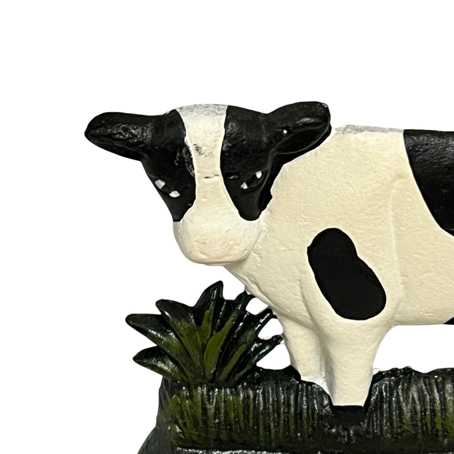 Cow figurine with black and white pattern on a white background