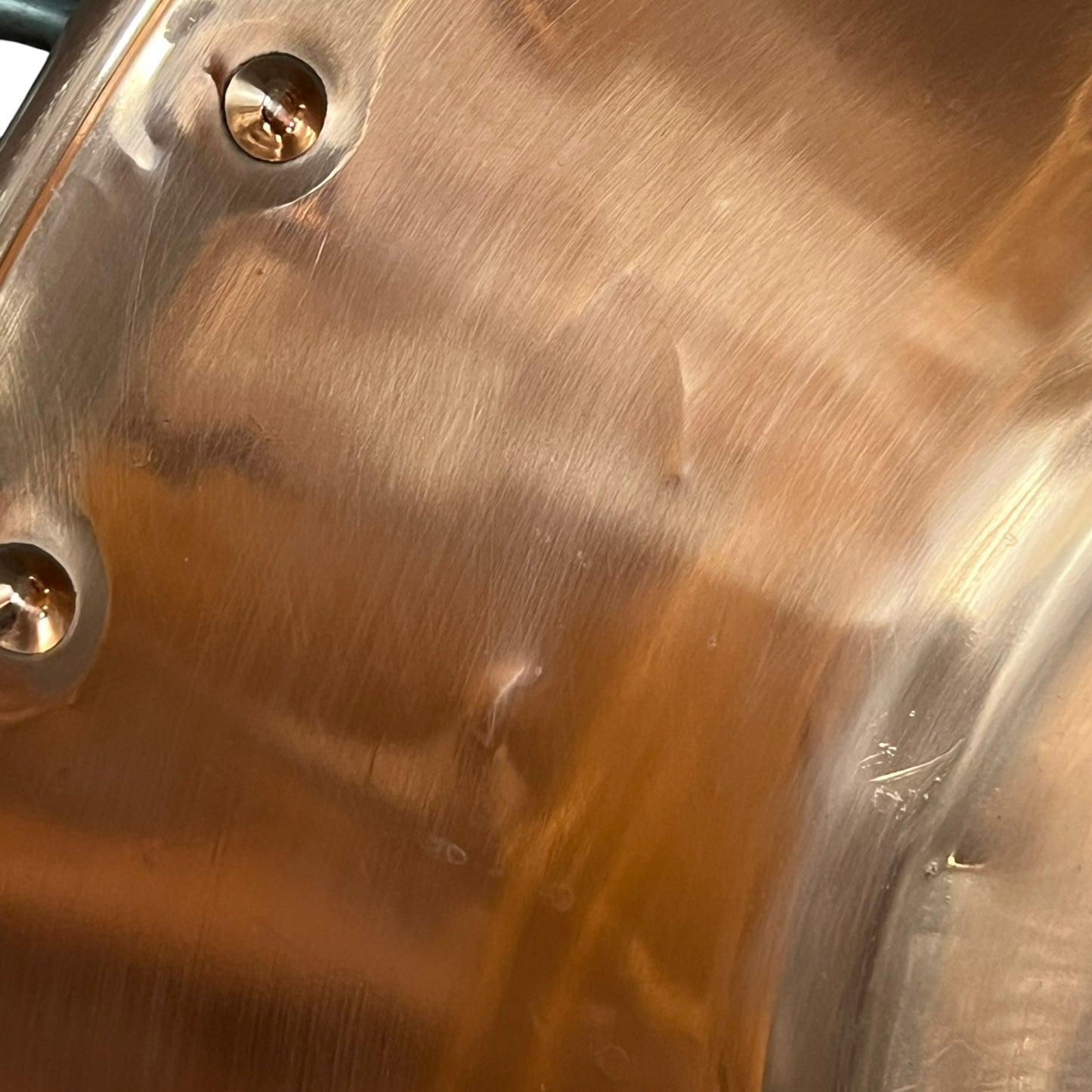 Close up of a French copper bathroom basin on a white background