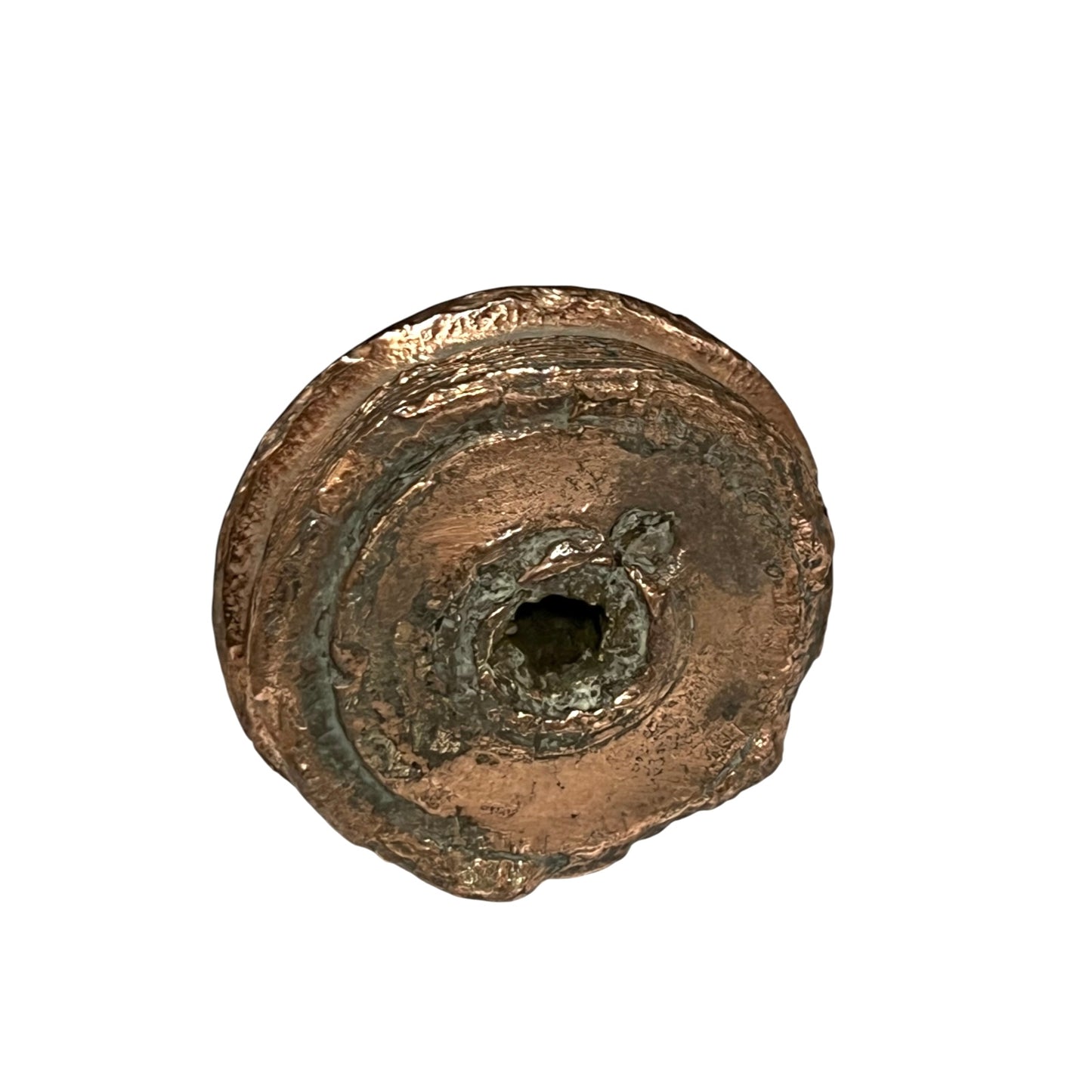 A small WW1 brass fuse paperweight with a textured finish on a white background Base view