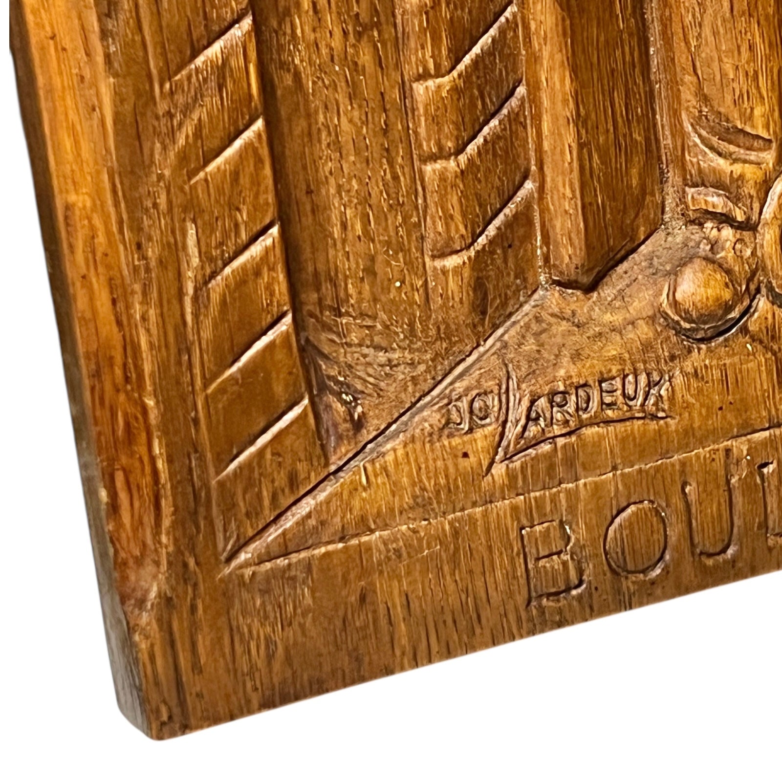 Wooden plaque with embossed design and 'Boulanger' branding on a white background