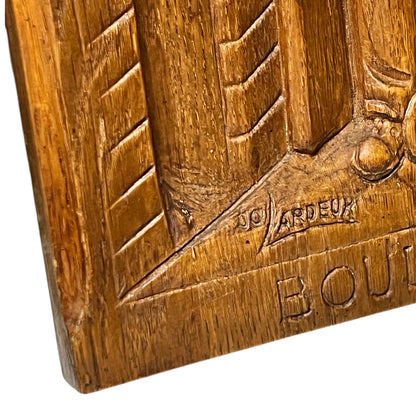 Wooden plaque with embossed design and 'Boulanger' branding on a white background