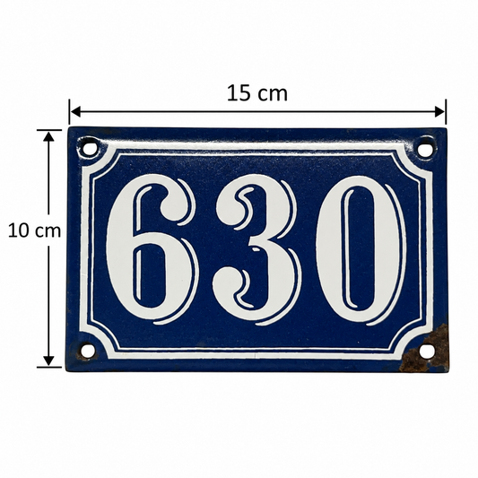A rectangular blue house number plaque with white numerals '630' and white decorative border, shown with dimension arrows and labels reading 15 cm wide and 10 cm tall on a white background.