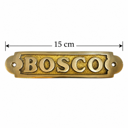 A brass Mousse door plaque with a black measure and text showing a size of 15cm displayed on a white background