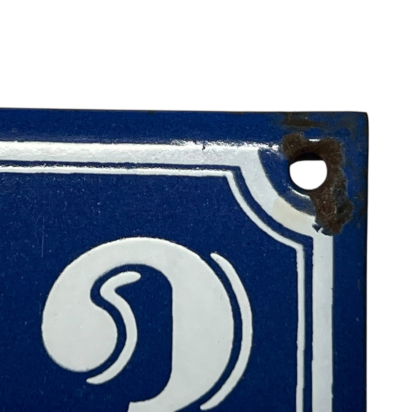 corner of enamel door number 