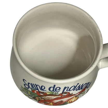 Ceramic mug with decorative design and text on a white background