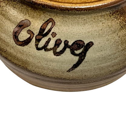 Close-up of a ceramic container with 'Olive' engraved on it, on a white background.