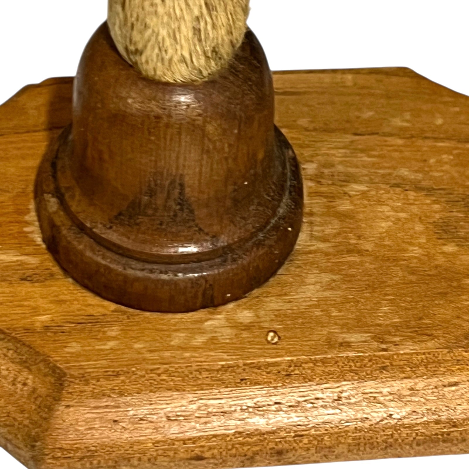 Close up of deer hoof hooks on wooden mounts on a white background