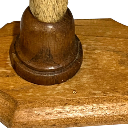 Close up of deer hoof hooks on wooden mounts on a white background