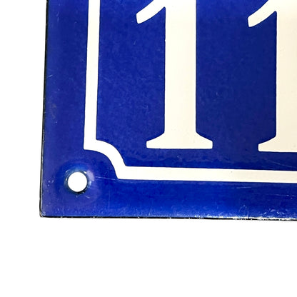 Blue and white rectangular sign with number '11'