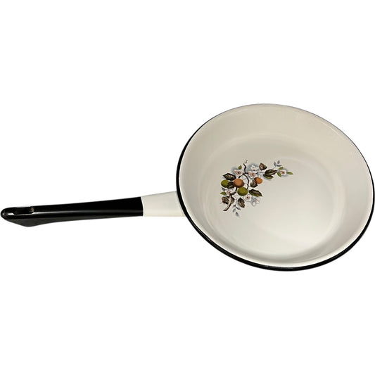White frying pan with floral design on a white background