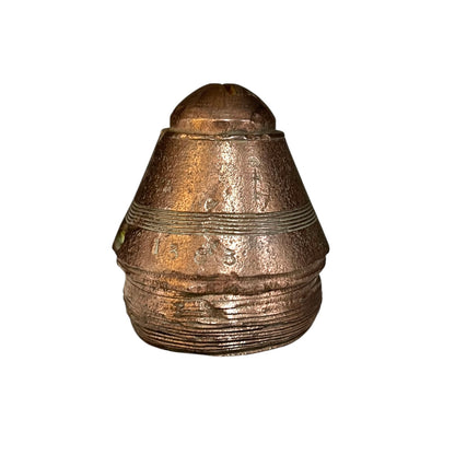 Bronze-colored artillery shell on a white background