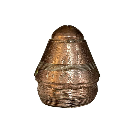 Bronze-colored artillery shell on a white background