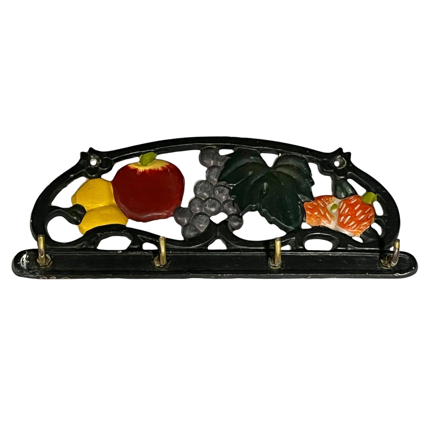 A vintage black cast iron fruit rack with decorative enamel fruit motifs including a red apple, yellow pear, dark green grapes with leaves, and an orange strawberry, shown on a plain white background.