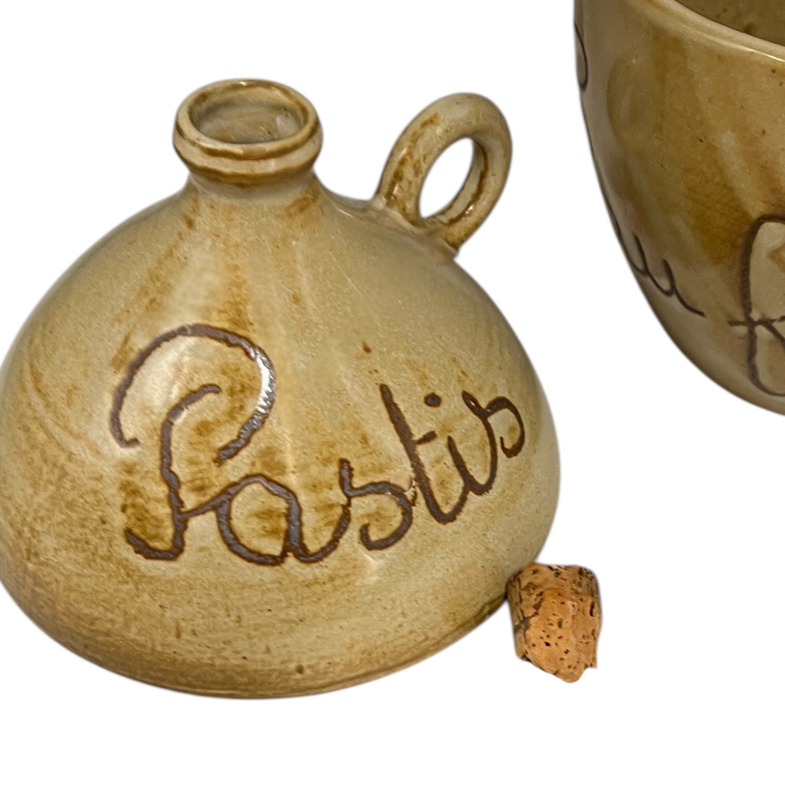 Small ceramic bottle labeled 'Pastis' on a white background