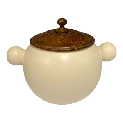 Ceramic jar with wooden lid on a white background