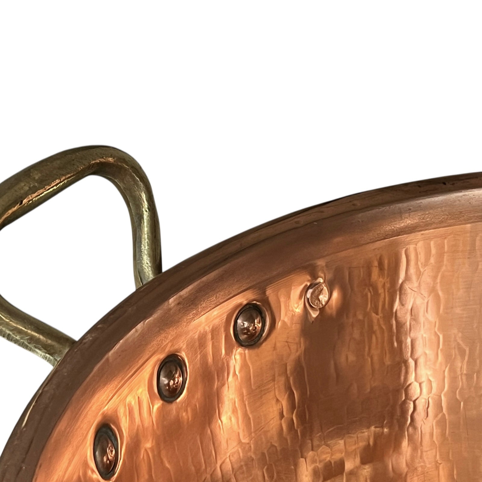 Close-up of copper sink with brass pop up waste on a white background