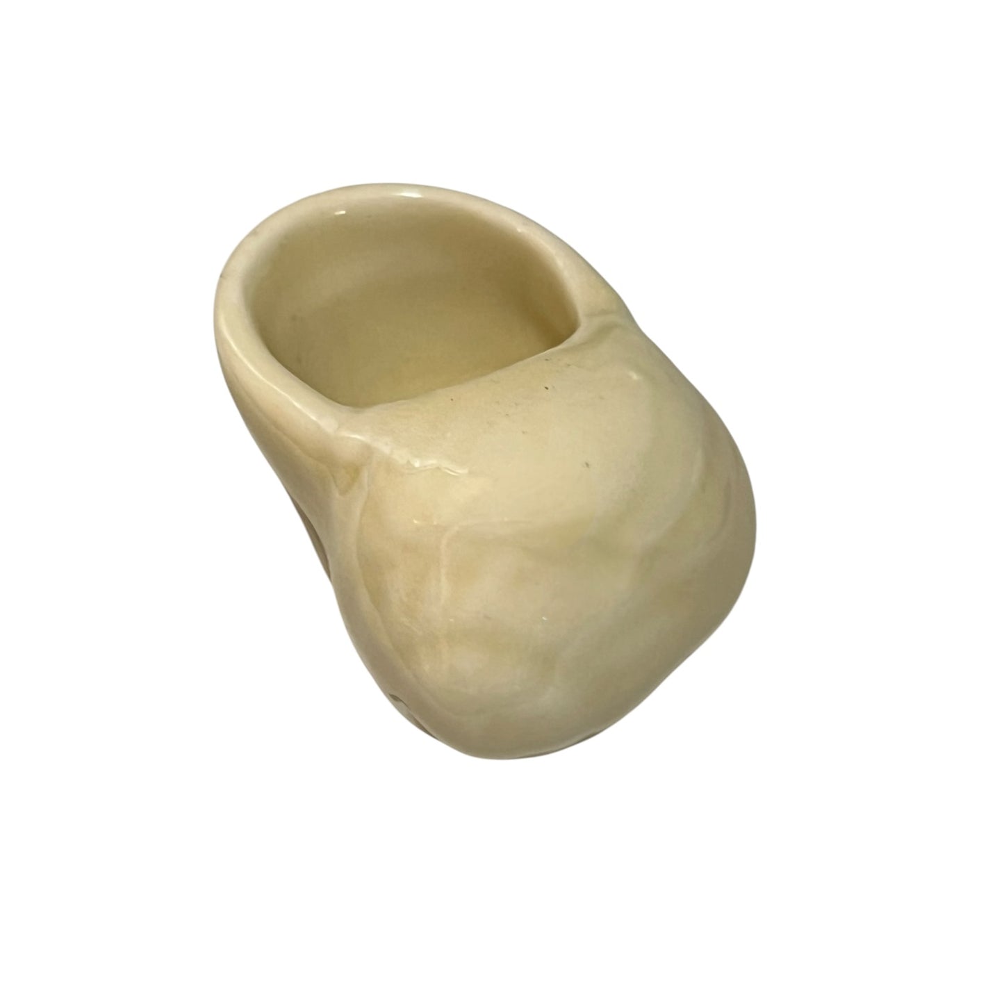 Beige ceramic snail shaped cup on a white background
