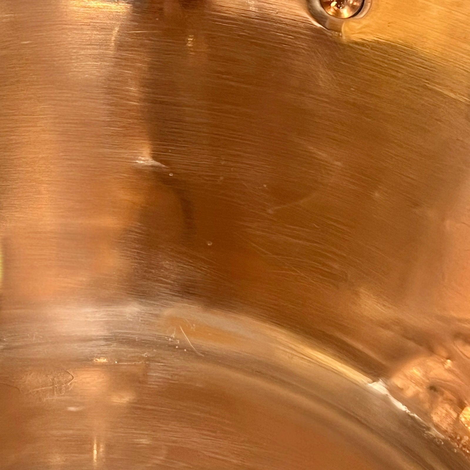 Close up of a French copper bathroom basin on a white background