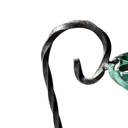 Close up of a wrought iron vintage plant stand on a white background 