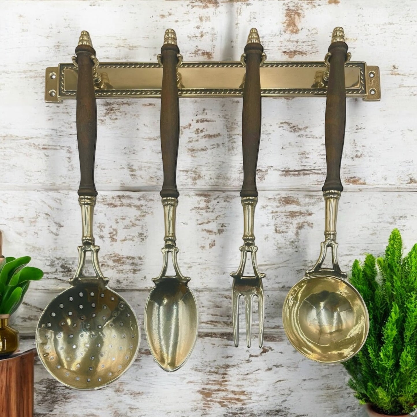 French brass and wooden 4 piece utensil set hanging from a brass bar