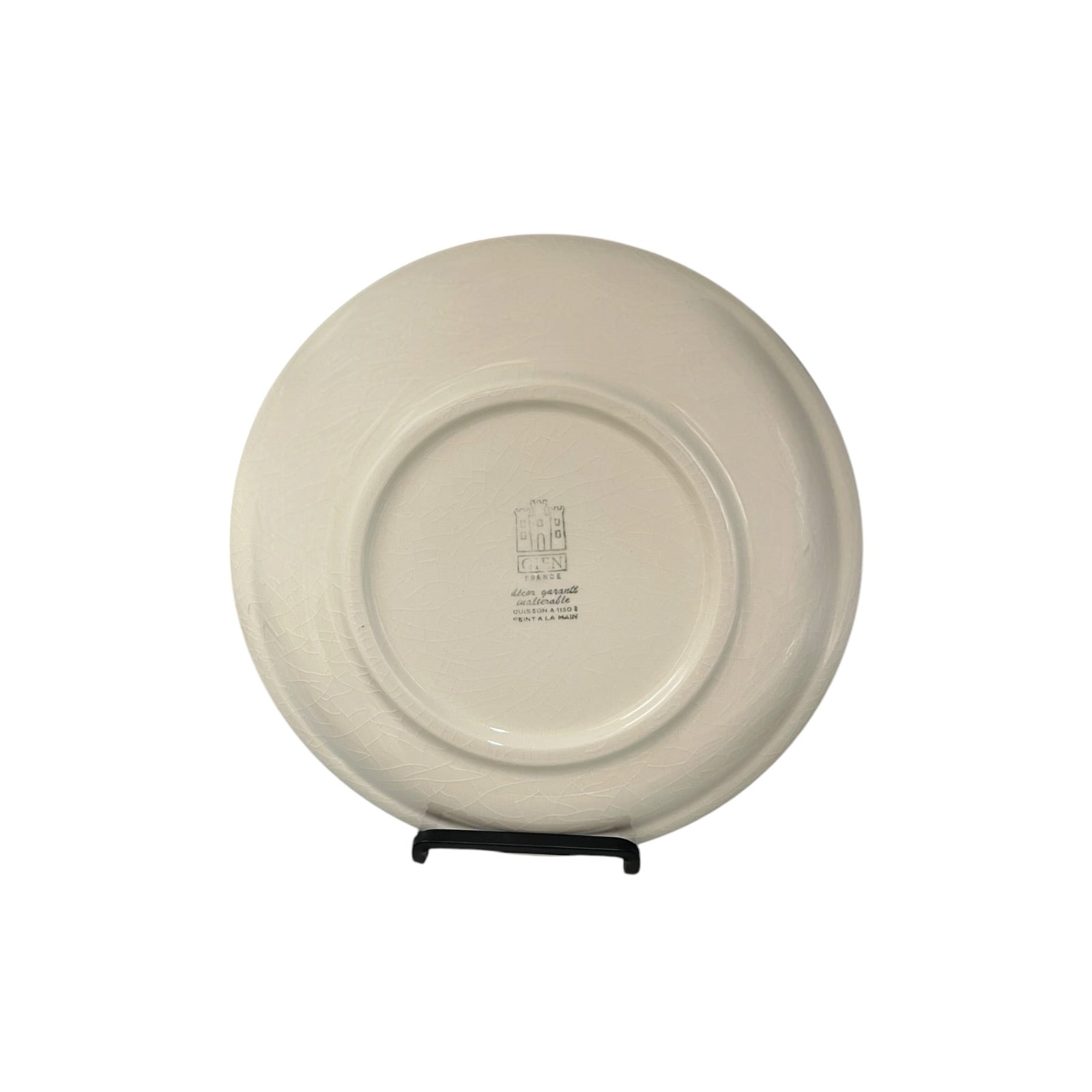 Beige ceramic plate on a stand with a visible brand logo on a white background