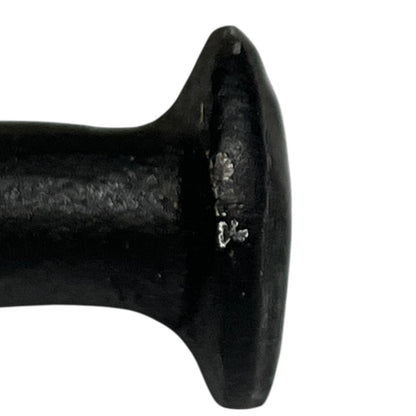 Close up of cow toilet paper holder with black and white pattern on a white background