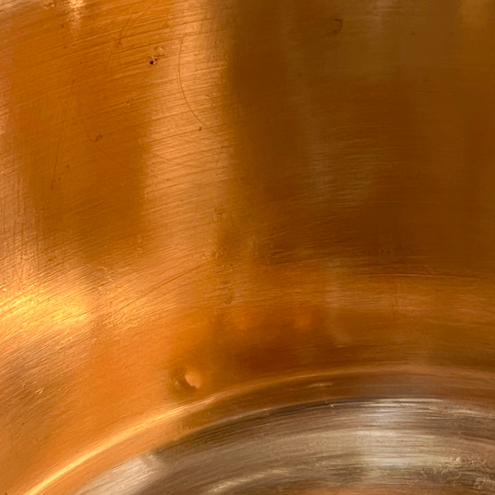 Close up of a French copper bathroom basin on a white background