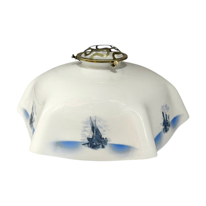 Decorative lamp shade with blue ship designs on a white background