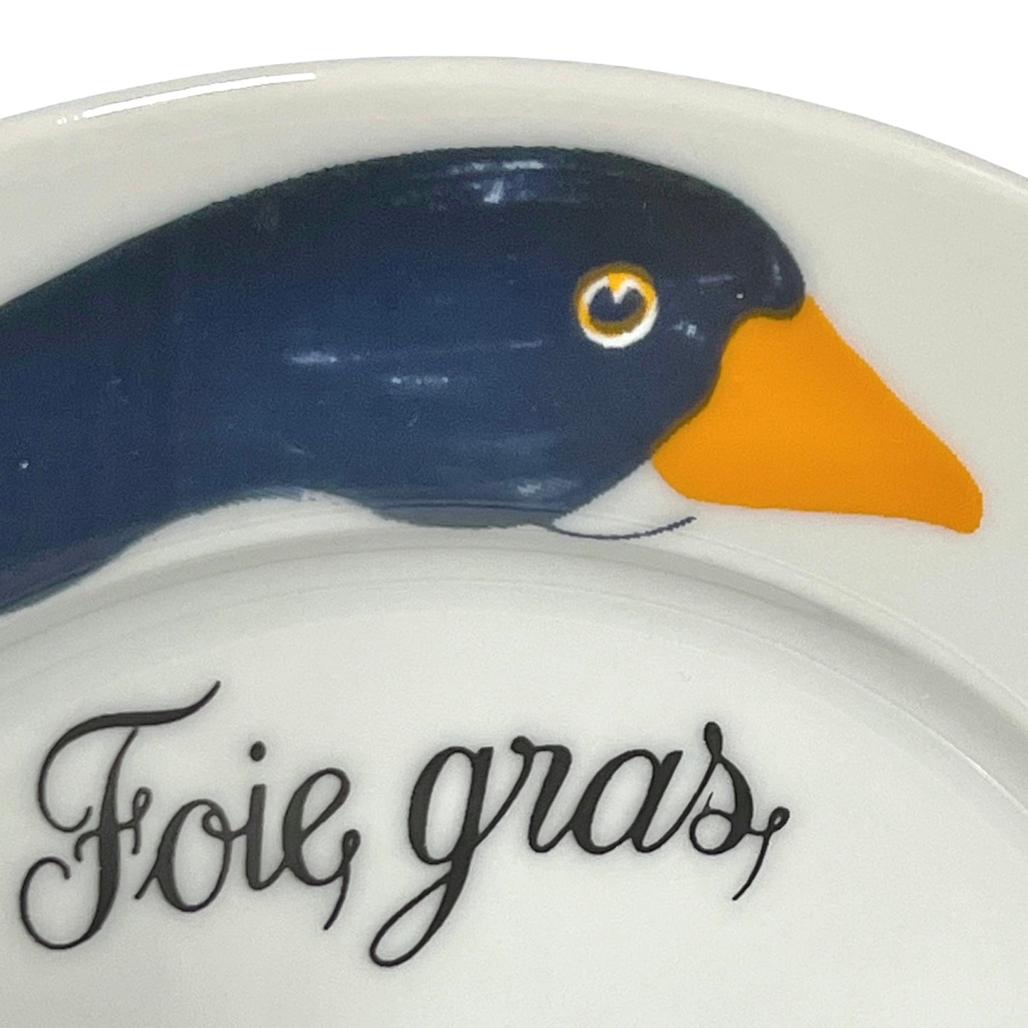 Decorative plate with a duck design and 'Foie gras' text on a white background