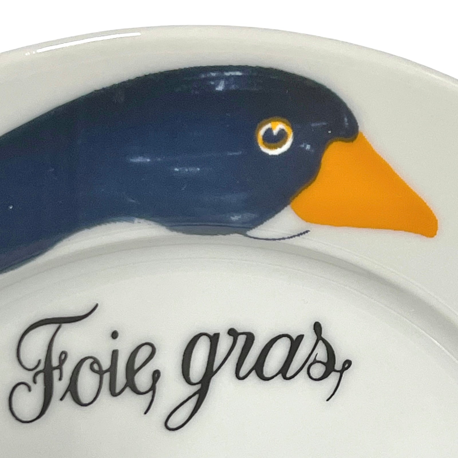Decorative plate with a duck design and 'Foie gras' text on a white background