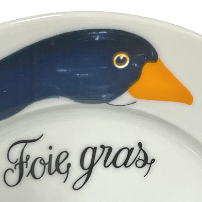 Decorative plate with a duck design and 'Foie gras' text on a white background