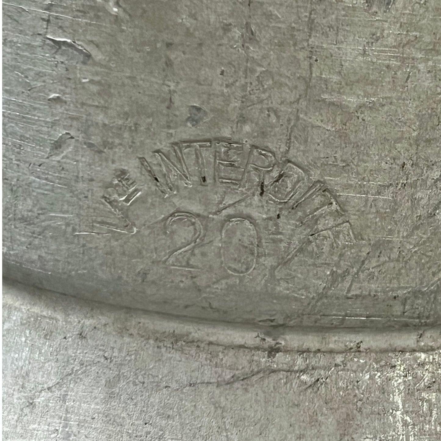 Metal surface with 'INTERDITE' and '20' embossed text