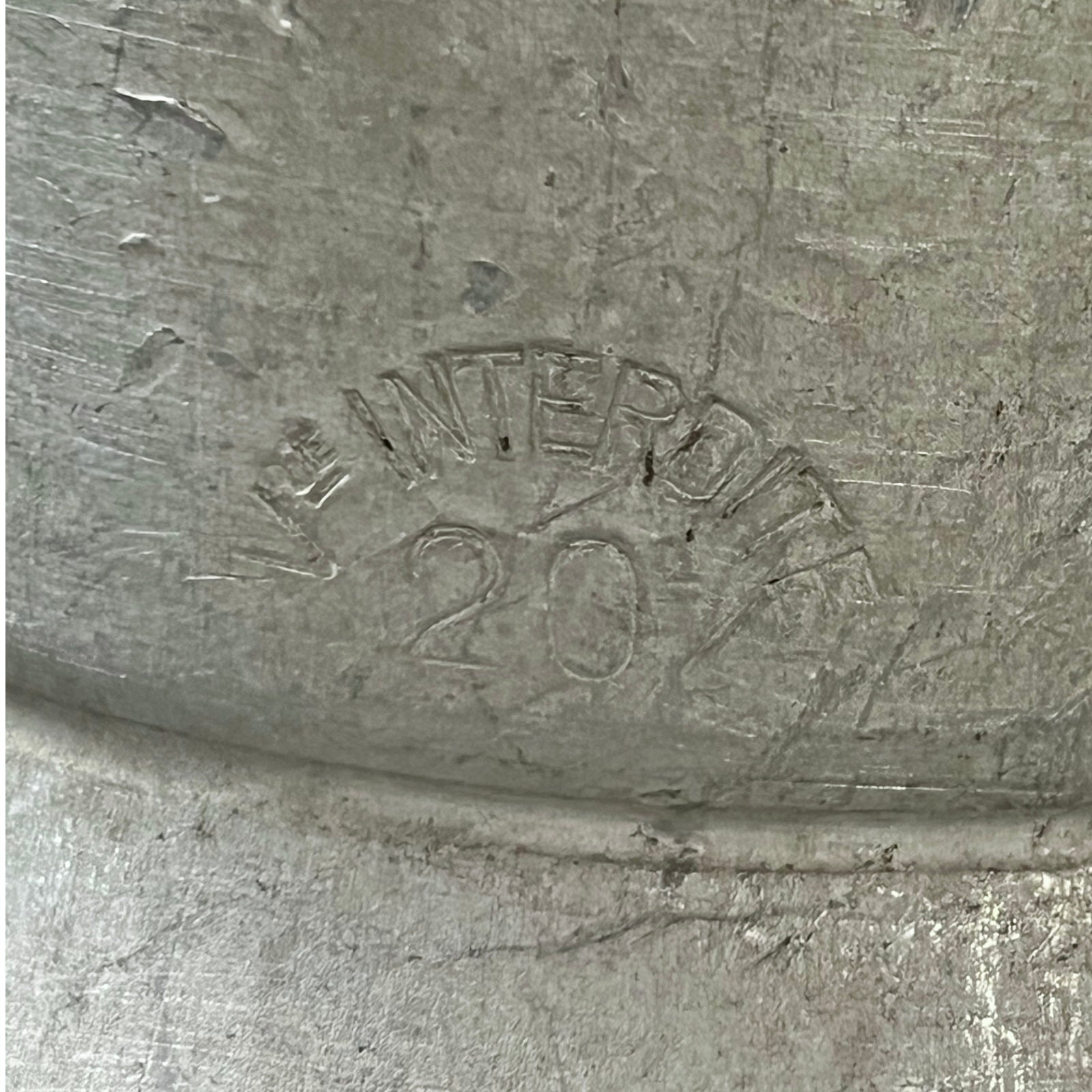 Metal surface with 'INTERDITE' and '20' embossed text