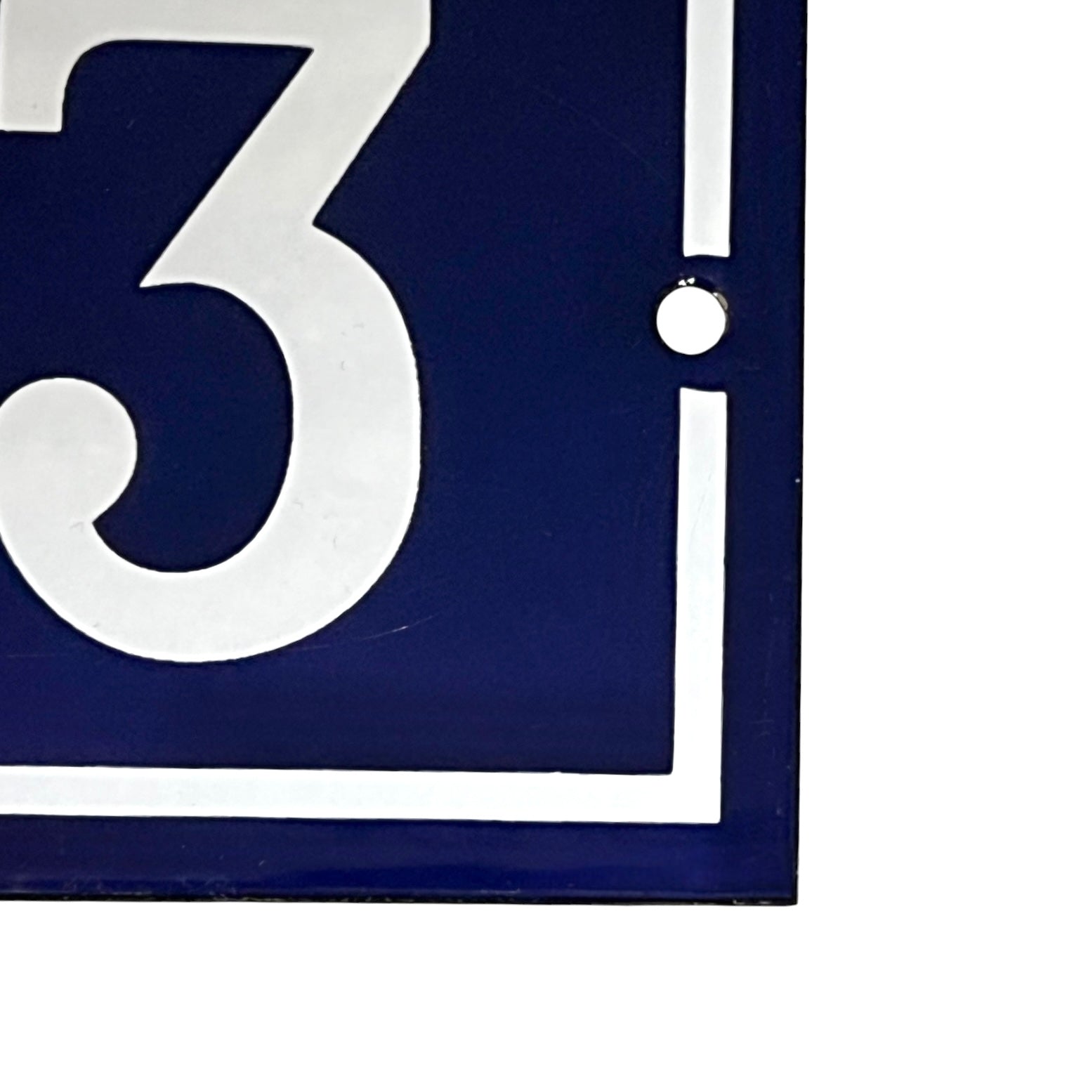 close up of a french blue door sign with white number '43' on a white background