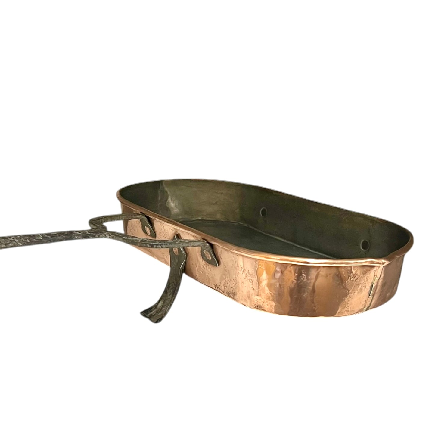 Antique French copper roasting pan with a long handle on a white background