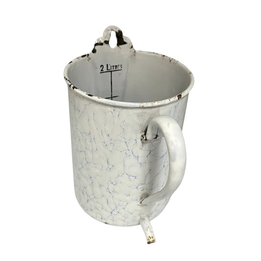 White and blue enamelled garden planter with marbled pattern on a white background