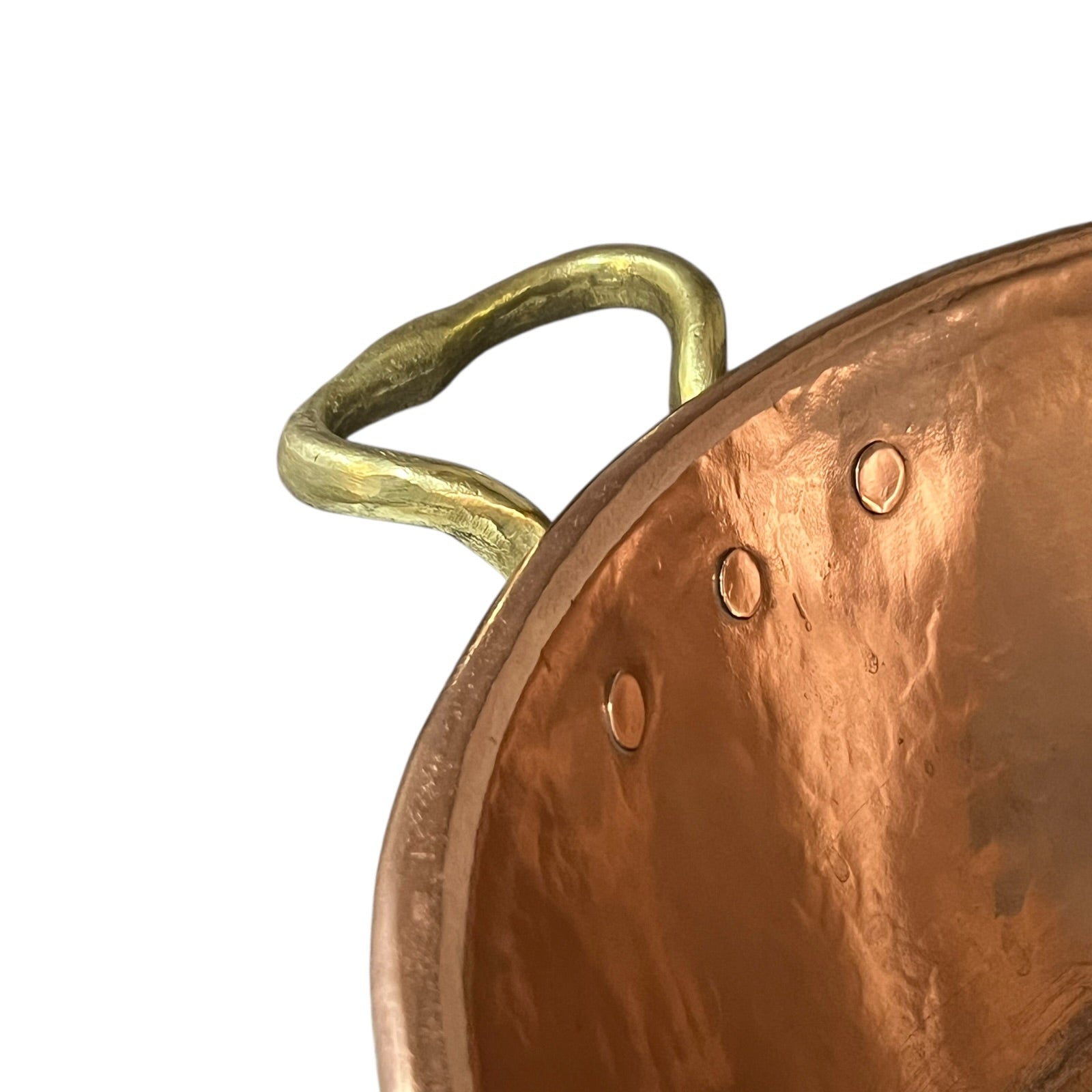 Close-up of a copper pot with a brass handle on a white background