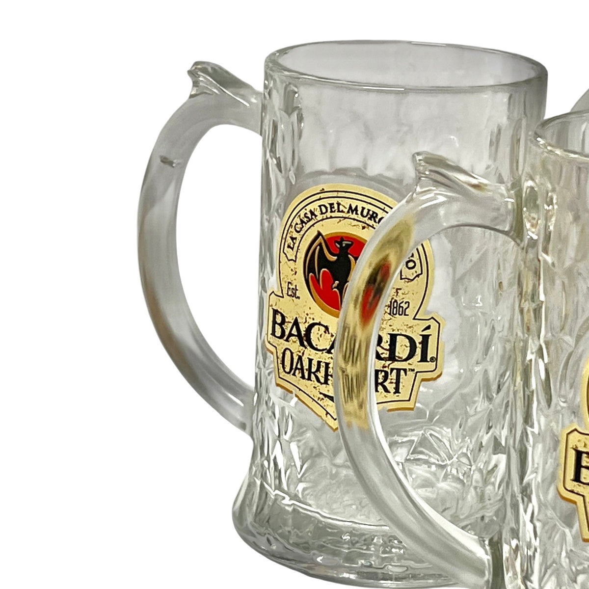A clear textured glass beer mug with a curved handle and a gold, black, and red Baderlart logo, shown on a white background.
