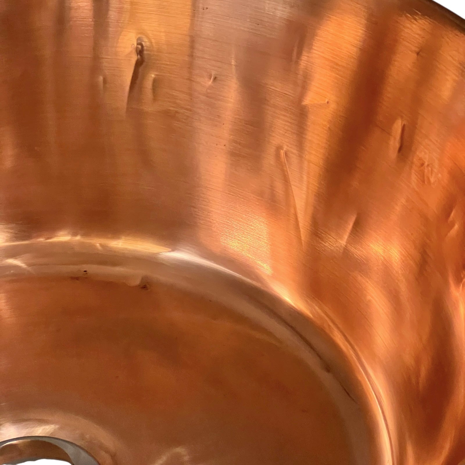 Close-up of a copper sink on a white background