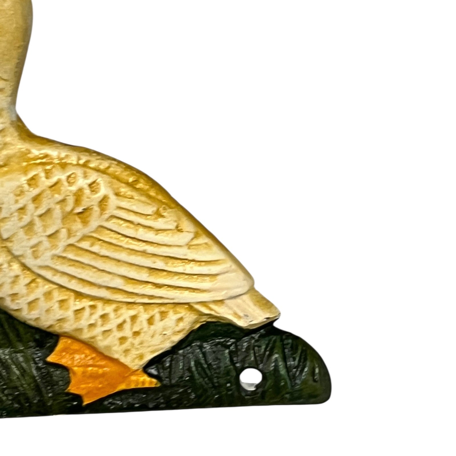 Close up of French farmhouse style goose cast iron toilet roll holder on a white background
