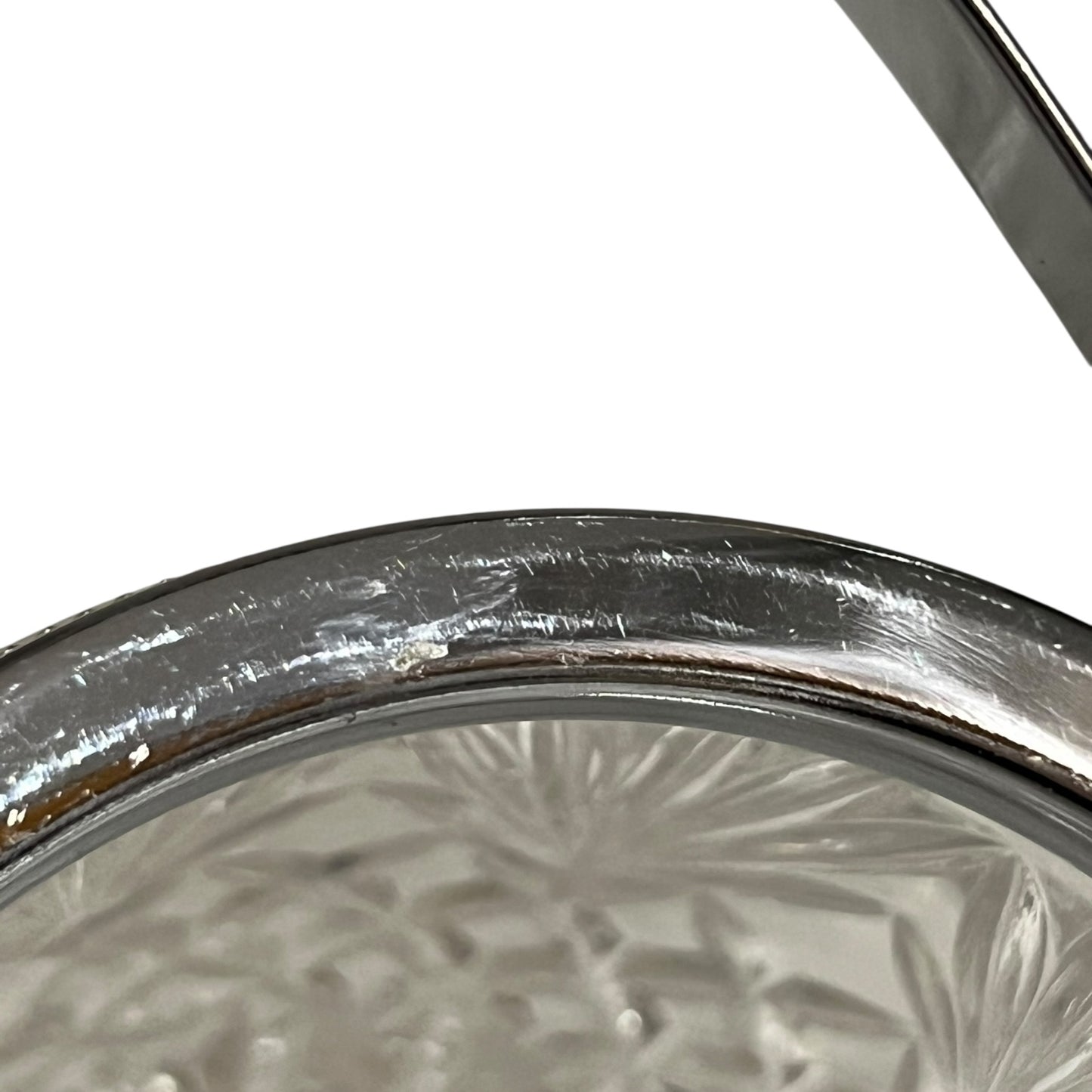 Close up of a French vintage glass ice bucket with silver rim on a white background